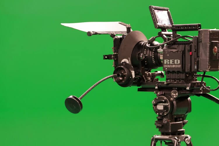 A professional camera with a green background